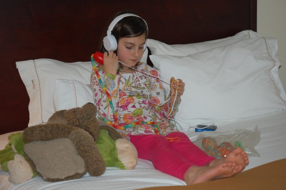 Henna jamming to a book while knitting away at our hotel in MO